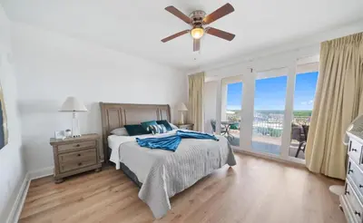 a bedroom with a bed and a ceiling fan at Spacious 3BR + Bunk Laketown Wharf Condo Sleeping 10 Near Beach in Panama City Beach