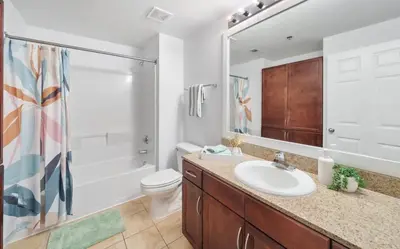 a bathroom with a sink and a toilet and a shower at Spacious 3BR + Bunk Laketown Wharf Condo Sleeping 10 Near Beach in Panama City Beach