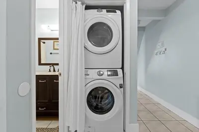 a washer and dryer sitting in a room at Quiet East End PCB Condo w/ Direct Beach Access & Balcony in Panama City Beach