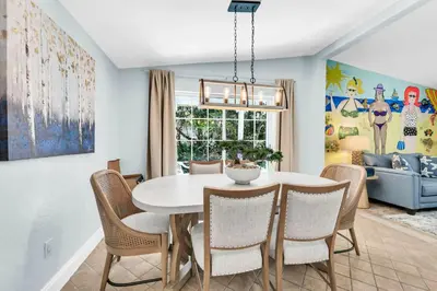 a dining room with a white table and chairs at Gone to the Beach cozy small home located near beach in Santa Rosa Beach