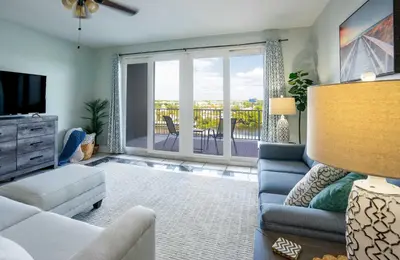 a living room with a couch and a tv at Wharftown Retreat - 8ppl in Panama City Beach