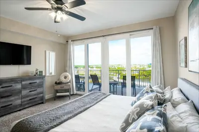 a bedroom with a bed with a ceiling fan at Wharftown Retreat - 8ppl in Panama City Beach