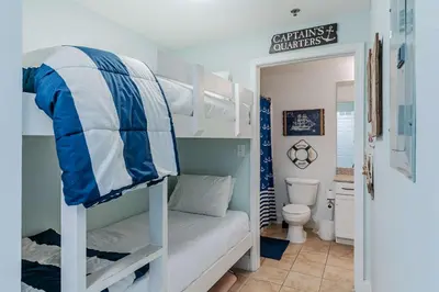 a room with two bunk beds and a toilet at Wharftown Retreat - 8ppl in Panama City Beach