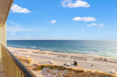 a view of the beach from a balcony at Commodore 0702 in Panama City Beach