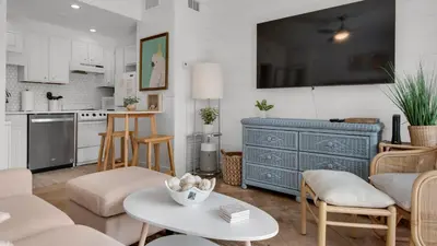 a kitchen and living room with a blue dresser at Emerald Hill 23 - The Little Pearl in Santa Rosa Beach