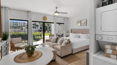 a bedroom with a bed and a living room at Emerald Hill 23 - The Little Pearl in Santa Rosa Beach