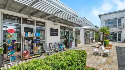 a beach supplies store with chairs in front of it at Prominence B - 30 Ray in Inlet Beach