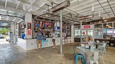 two people standing at the counter of a restaurant at Prominence B - 30 Ray in Inlet Beach