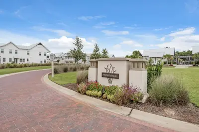 a building with a sign on the side of a road at Prominence B - 30 Ray in Inlet Beach