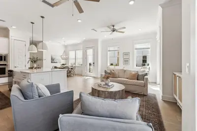 a living room with two couches and a kitchen at Coastal Grace in Inlet Beach