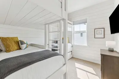 a white bedroom with a bed and a window at Coastal Grace in Inlet Beach