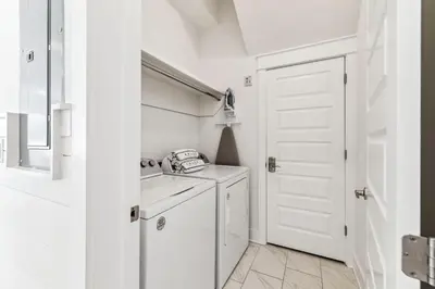 a white kitchen with a sink and a washing machine at Coastal Grace in Inlet Beach