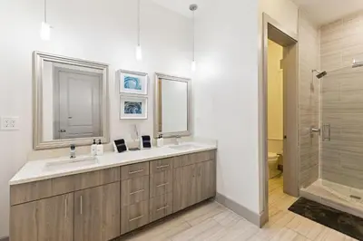 a bathroom with two sinks and a shower at Poolside Paradise in Inlet Beach