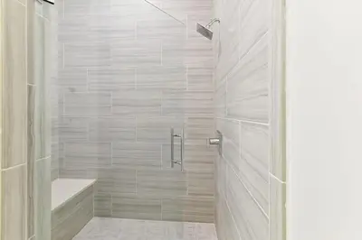 a bathroom with a shower with a glass door at Poolside Paradise in Inlet Beach