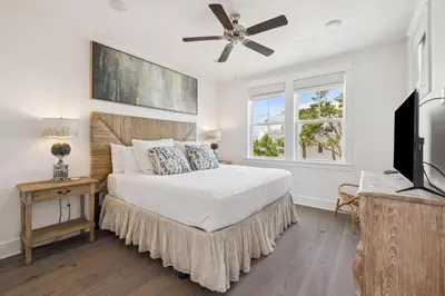 a bedroom with a bed with a ceiling fan at Our Oasis in Inlet Beach