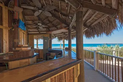 a porch of a resort with the beach in the background at Calypso 1-202 by Emerald Coast Retreats in Panama City Beach