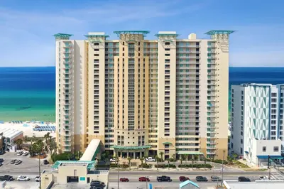 a large apartment building with the ocean in the background at Rare Corner-Unit at AQUA 201 Private Elevator, Multiple Balconies Sunset Views in Panama City Beach