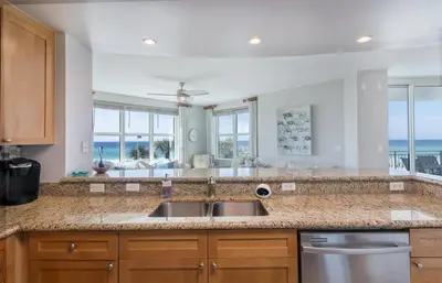 a kitchen with a sink and a counter top at Rare Corner-Unit at AQUA 201 Private Elevator, Multiple Balconies Sunset Views in Panama City Beach