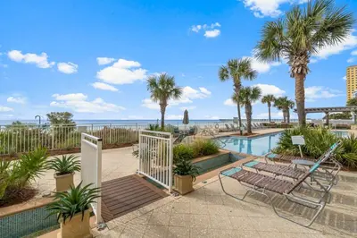 a resort with a pool and palm trees at Rare Corner-Unit at AQUA 201 Private Elevator, Multiple Balconies Sunset Views in Panama City Beach
