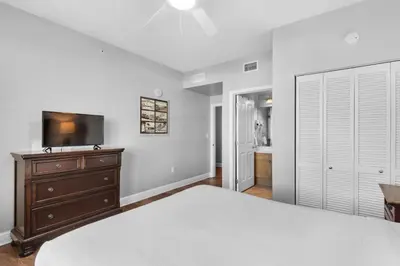 a bedroom with a bed and a flat screen tv at Aqua 0309 in Panama City Beach