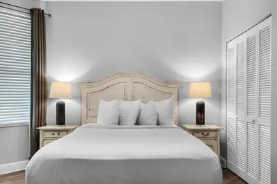 a bedroom with a large white bed with two night stands at Aqua 0309 in Panama City Beach