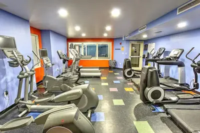 a gym with a bunch of treadmills and machines at Beach Please in Panama City Beach