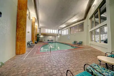 a large indoor swimming pool in a building at Beach Please in Panama City Beach