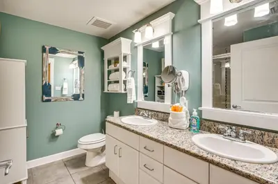 a bathroom with two sinks and a toilet at Scenic Balcony and Resort Perks PCB Condo! in Panama City Beach