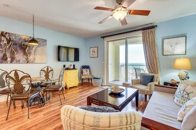 a living room with a couch and a table and chairs at Scenic Balcony and Resort Perks PCB Condo! in Panama City Beach