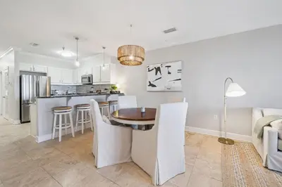 a kitchen and living room with a table and chairs at FL(S) - The Oxford - 10343 E Co Hwy 30A Unit 410 in Inlet Beach