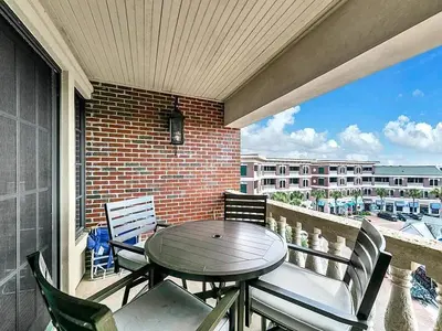 a patio with a table and chairs on a balcony at FL(S) - The Oxford - 10343 E Co Hwy 30A Unit 410 in Inlet Beach
