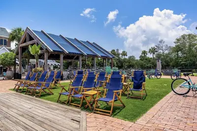 a group of blue chairs sitting on the grass at FL(S) - The Oxford - 10343 E Co Hwy 30A Unit 410 in Inlet Beach