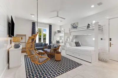 a bedroom with a bunk bed and a swing at Salt & Light in Santa Rosa Beach