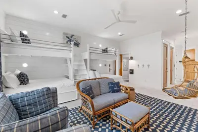 a bedroom with a bed and a couch and chairs at Salt & Light in Santa Rosa Beach