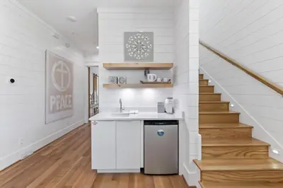 a kitchen with a sink and a staircase at Salt & Light in Santa Rosa Beach