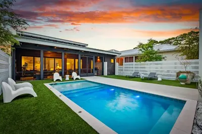 a swimming pool in the yard of a house at Seagrove Surf Shack in Santa Rosa Beach