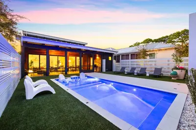a swimming pool in the backyard of a house at Seagrove Surf Shack in Santa Rosa Beach