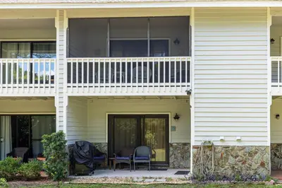 a front porch of a house with chairs on it at Somewhere in the Sun in Santa Rosa Beach