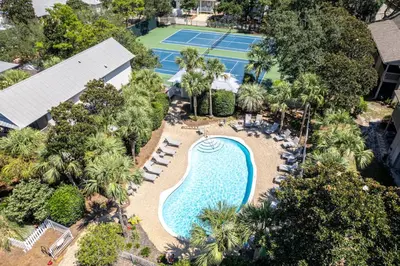 an overhead view of a pool and tennis courts at Somewhere in the Sun in Santa Rosa Beach