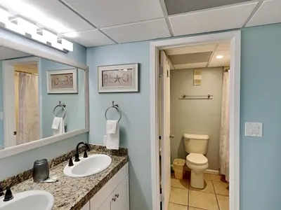 a bathroom with two sinks and a toilet at Edgewater Tower III #705 in Panama City Beach