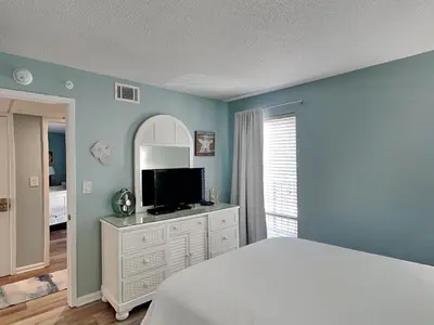 a bedroom with a bed and a television on a dresser at Edgewater Tower III #705 in Panama City Beach