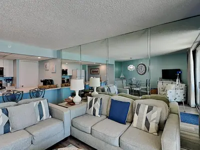 a living room with couches and a dining room at Edgewater Tower III #705 in Panama City Beach