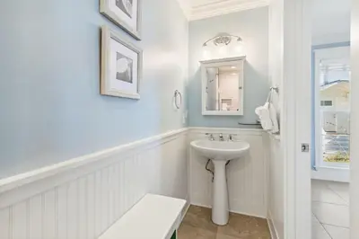 a white bathroom with a sink and a mirror at Diamond Dunes in Inlet Beach