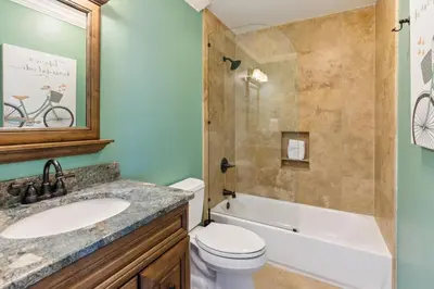 a bathroom with a toilet and a sink and a shower at Diamond Dunes in Inlet Beach