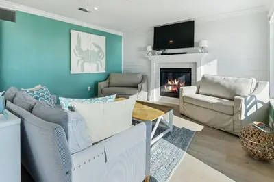 a living room with a couch and a fireplace at Diamond Dunes in Inlet Beach