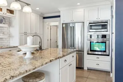 a kitchen with white cabinets and a counter top at Diamond Dunes in Inlet Beach