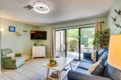 a living room with a couch and a table at Walk to Shore PCB Home with Balcony and Pool Access! in Panama City Beach