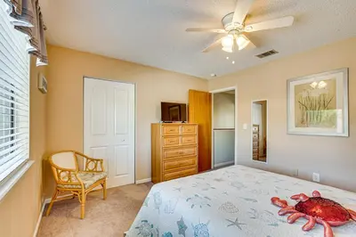 a bedroom with a bed and a ceiling fan at Walk to Shore PCB Home with Balcony and Pool Access! in Panama City Beach