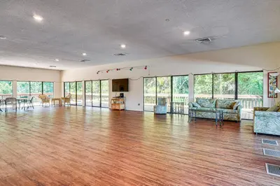 an empty living room with a hard wood floor at Walk to Shore PCB Home with Balcony and Pool Access! in Panama City Beach