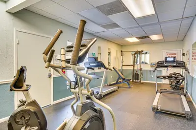 a gym with treadmills and ellipticals in a room at Walk to Shore PCB Home with Balcony and Pool Access! in Panama City Beach